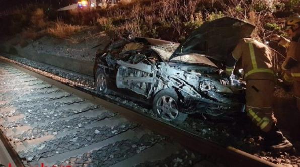 Unusual event: a train rolls a car and there is only a slight injury